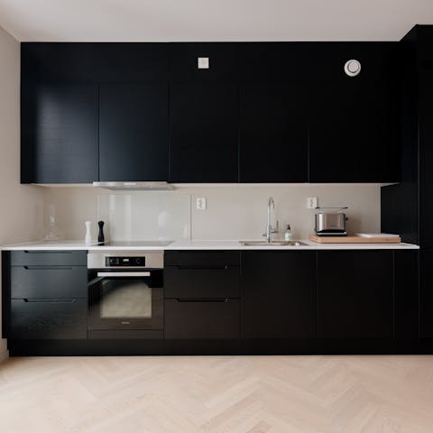 Prepare a traditional Norwegian breakfast of bread, brown cheese, and milk in the sleek kitchenette