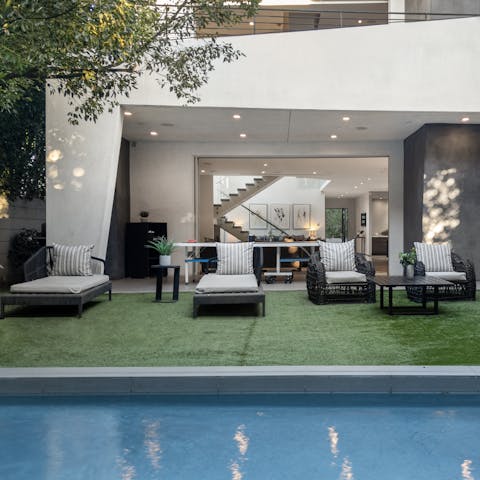 Spend cloudless mornings relaxing by the pool in the pristine garden