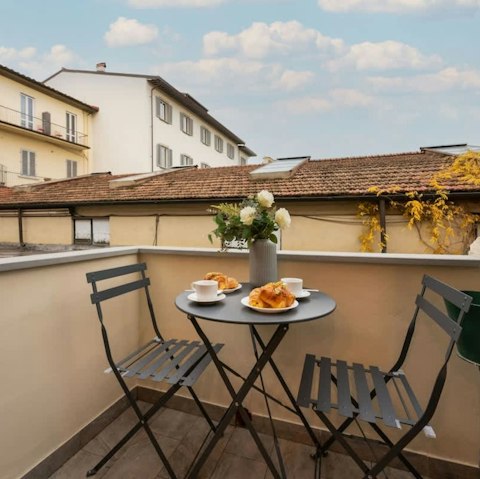 Sit out over Florence's terracotta rooftops with coffee and croissants