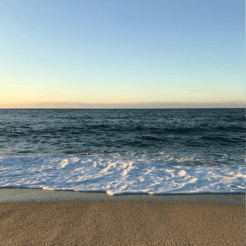 Sink your toes in the sand at Playa Guadalmina, a nine-minute drive away