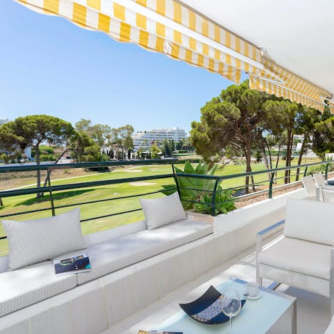 Sip sangria on a private terrace overlooking the golf course