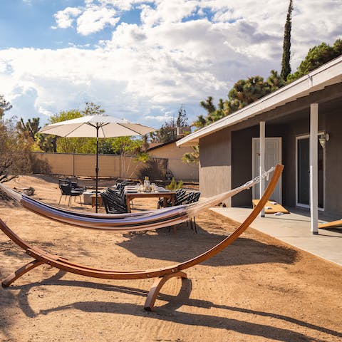 Spend lazy days curled up with a book in the hammock