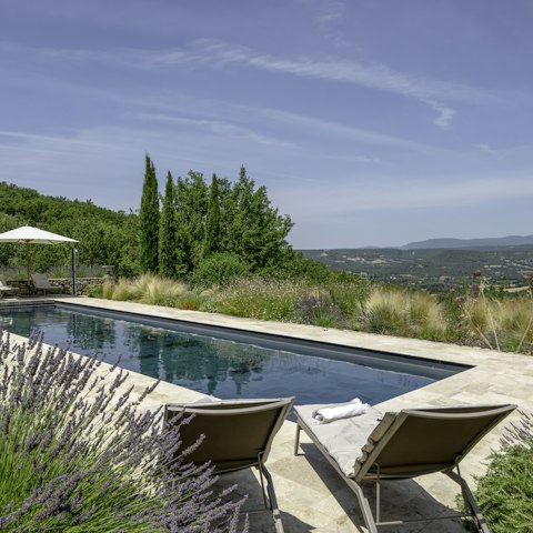 Stretch out by the pool with sweeping views across the countryside