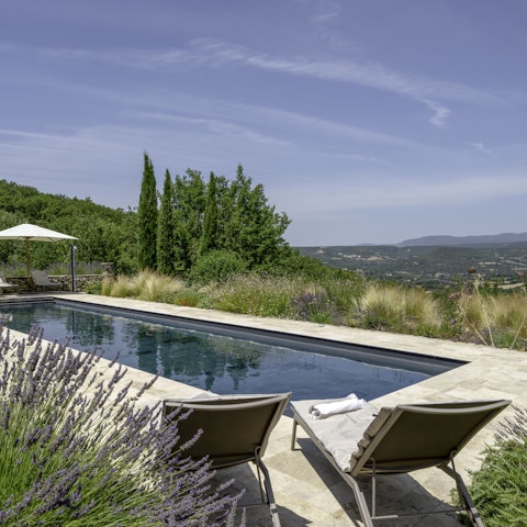 Stretch out by the pool with sweeping views across the countryside