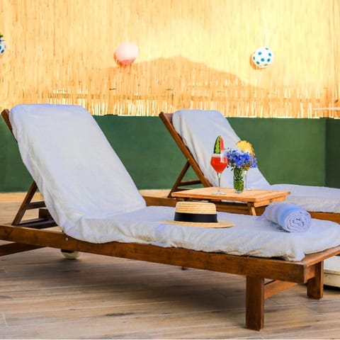 Recline on a lounger with a novel and an ice-cold beverage