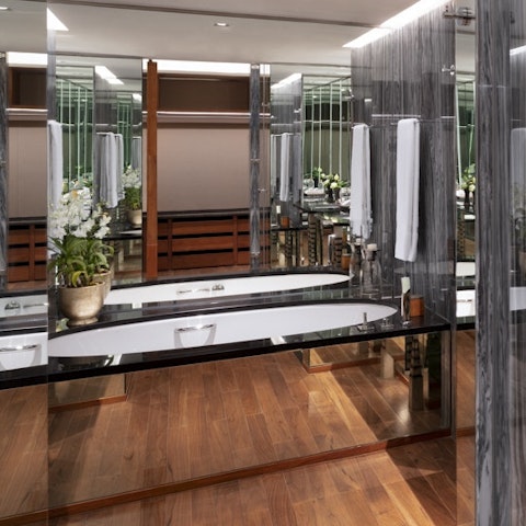 Indulge yourself in the luxurious bathroom, soaking in the bubbly waters of the deep tub