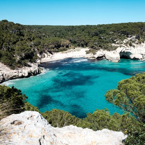 Try your hand at windsurfing at Son Xoriguer Beach, a ten-minute drive away