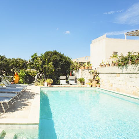 Swim laps in the crystal-clear swimming pool in the heat of the day