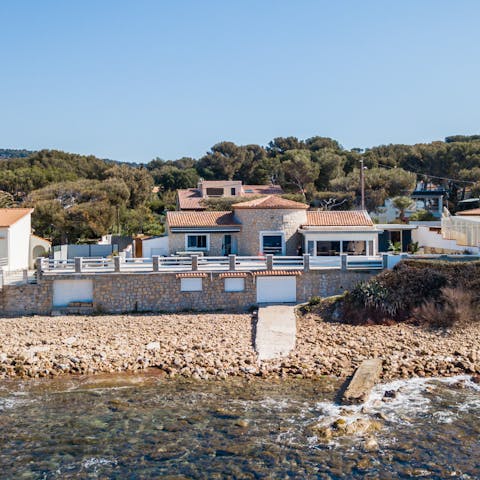 Pad down to the pebbled beach after a dip in the pool