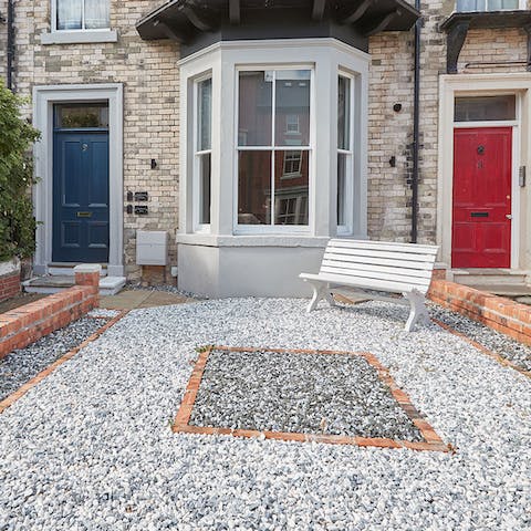 Get some fresh air on the bench in the shared front garden