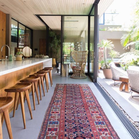 Enjoy seamless indoor/outdoor living thanks to retractable sliding glass walls