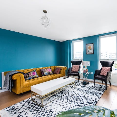 Relax on the plush dark gold sofa after a busy day of sightseeing in this wonderful city