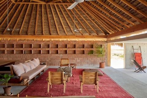 Drift out to open sand beneath a thatched palapa