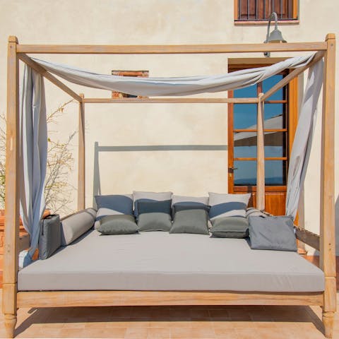 Relax with a good book on the comfy outdoor daybed