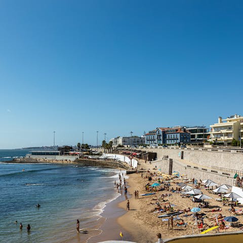 Stay a fifteen-minute walk from the soft sand at Carcavelos Beach