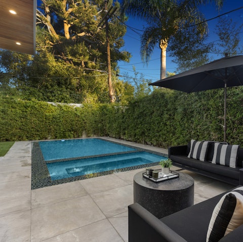 Hang out by the private pool and hot tub on a warm afternoon