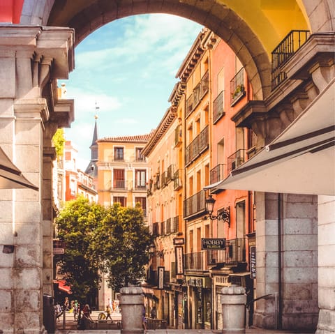 Embrace the soft pink hues and warm light of central Madrid