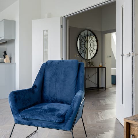 Find a sunny spot to read in the blue velvet upholstery