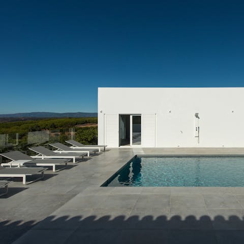 Stretch out poolside before cooling off in your pristine pool