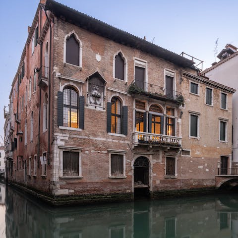Watch gondolas glide silently by from the private balcony