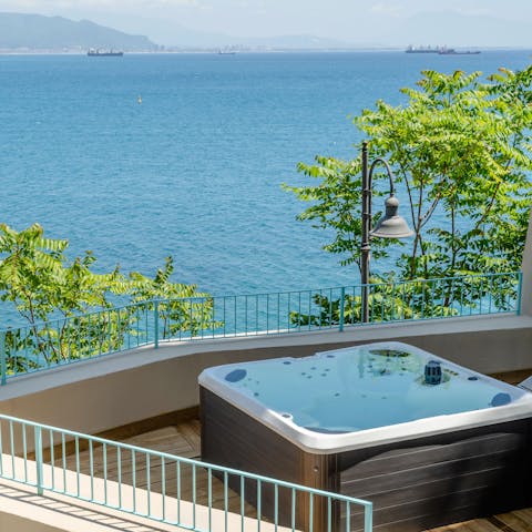Gaze out to sea while relaxing in the Jacuzzi
