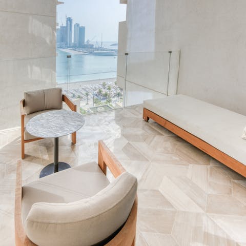 Take in views over the beach from the covered balcony, a cool drink in hand