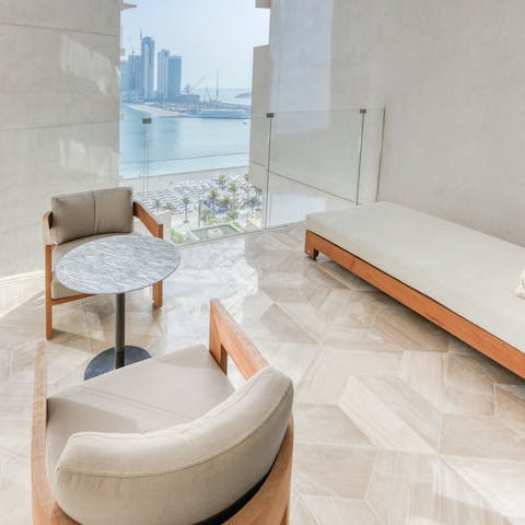 Take in views over the beach from the covered balcony, a cool drink in hand