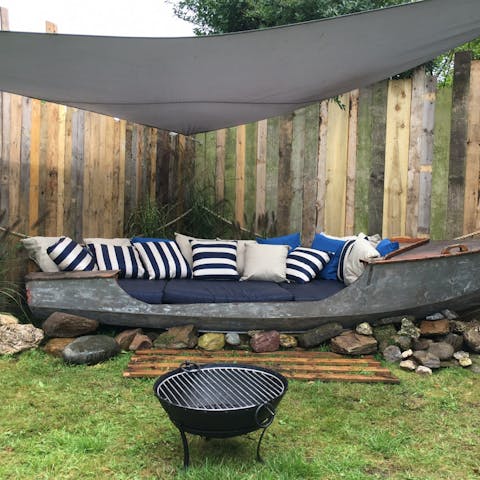Spend long evenings outside around the fire pit in the converted boat seating