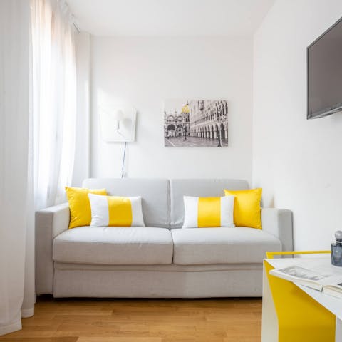 Kick back in the bright living room with a glass of wine after a day of exploring