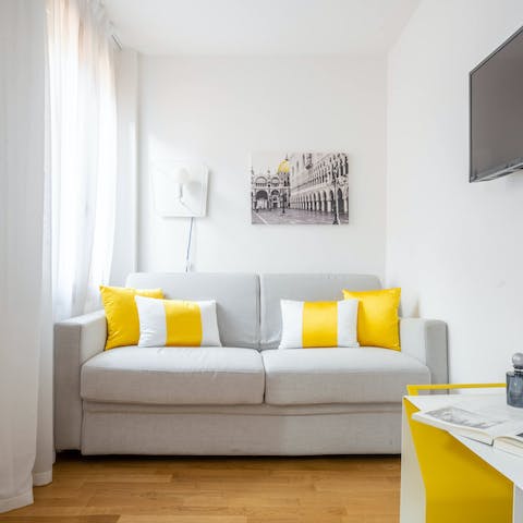 Kick back in the bright living room with a glass of wine after a day of exploring