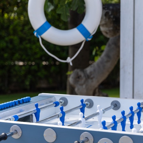 Play an outdoor game of foosball, pool, or table tennis