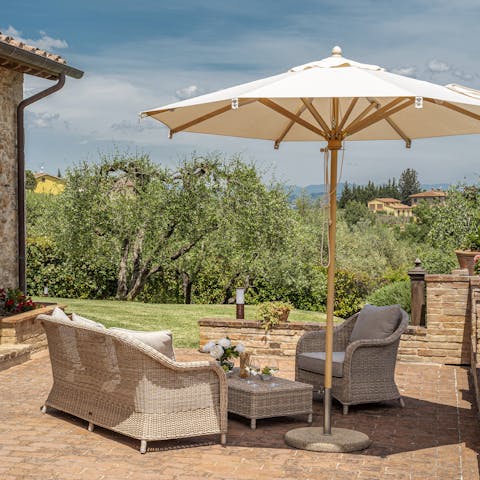 Admire the typically Tuscan views, a glass of wine in hand