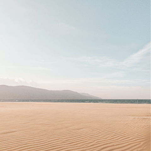 While away the hours on Glaros Beach, a ten-minute walk from your villa