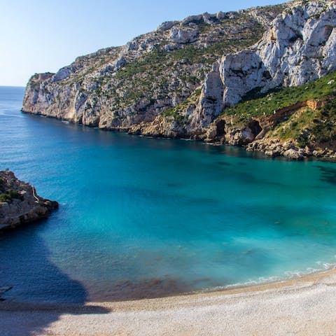 Explore the secluded coves and sandy beaches in Jávea – Platja de la Granadella is an eight-minute drive away