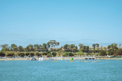 Kayak or paddleboard on calm Newport Dunes lagoon, perfect for all ages