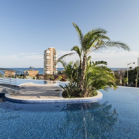 Float and chat in the shared swimming pool as you enjoy views of the sea