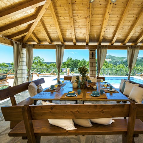 Set up for long, leisurely lunches at the wooden table in the shade