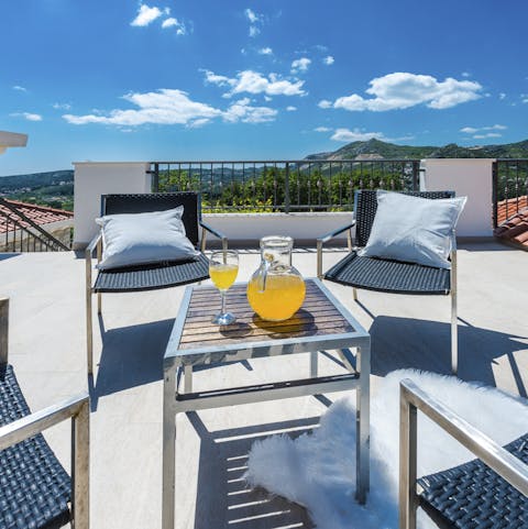 Head up to the suntrap rooftop terrace for a cold drink overlooking the mountains