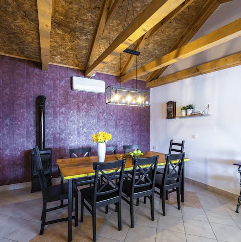 Enjoy a rustic, farmhouse meal at the dining table next to the wood-burner