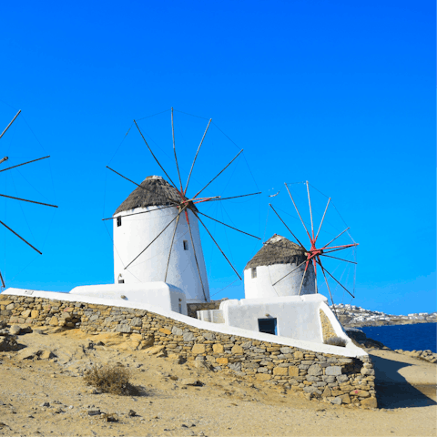 Discover the windmills of Mykonos, a ten-minute drive away