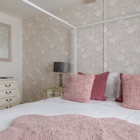 Enjoy a restful night's sleep in the comfortable four-poster bed