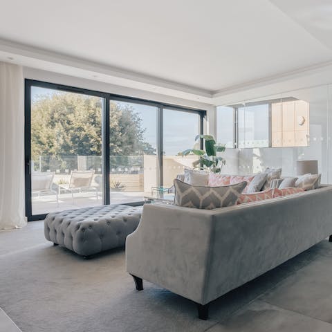 Unwind in the plush living room bathed in natural light