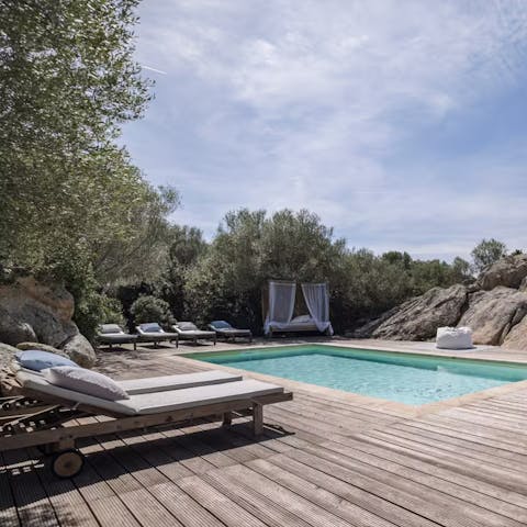 Relax on a day bed or lounger by the shared pool
