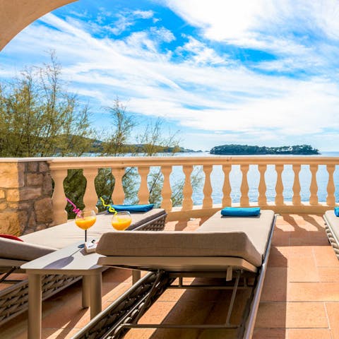 Make it happy hour, every hour while lounging before the sparkling seascape