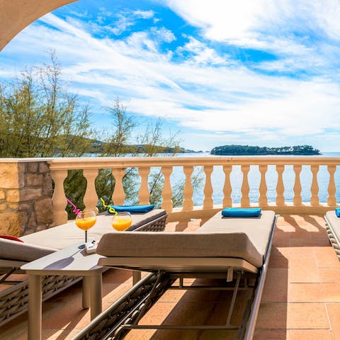 Make it happy hour, every hour while lounging before the sparkling seascape