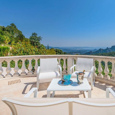 Sip a cocktail on the balcony overlooking the rolling hills, with the Bay of Cannes in the distance