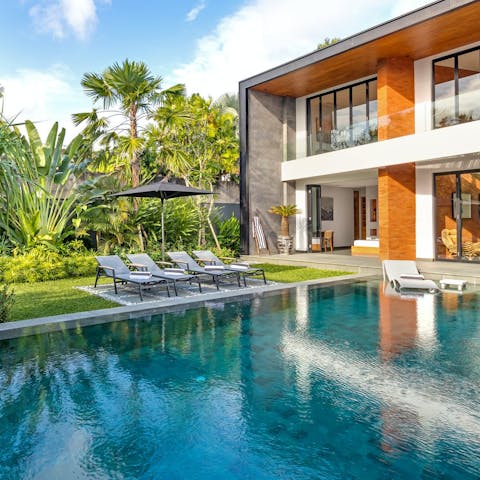 Unwind on the lawn, surrounded by palm trees