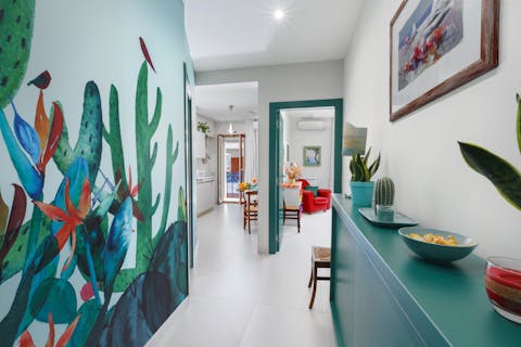 Relax amongst the home's fun and colourful interiors, with artistic murals and decor