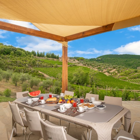 Dine alfresco with views across vineyards and olive groves