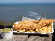 Enjoy Delicious Fish and Chips with Stunning Bay Views